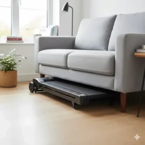 A compact, foldable walking treadmill tucked neatly under a sofa in a typical UK flat.