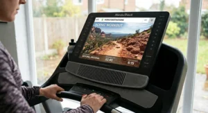 An iFit treadmill console displaying a high-definition guided run through a scenic international location.