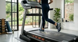 A person running on a quiet, reliable electric treadmill for daily use without disturbing others in a semi-detached house.