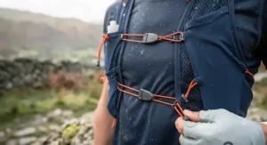Sternum strap and compression system adjustments on a custom-fit race vest for ultramarathon runners.