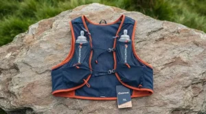 Flat lay of a running hydration vest displaying front flask pockets and storage compartments.