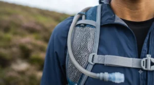 Detailed shot of the breathable, sweat-wicking mesh shoulder straps on a running backpack with water bladder.