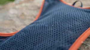 Close-up of breathable, moisture-wicking mesh fabric on a lightweight running hydration vest.