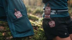 Flatlay displaying different ways to carry running energy gels using a race belt, running shorts pockets, and a hydration vest.