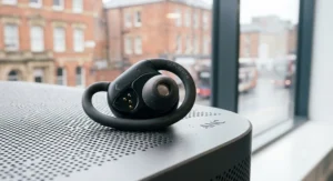 Active noise-cancelling wireless earbuds blocking out gym ambient noise for a focused treadmill run.