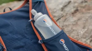 Included soft hydration flasks nestled in the front chest pockets of a running vest.