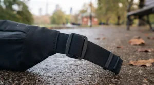 Demonstrating the adjustable strap on a running waist belt to ensure a bounce-free fit for all body types.