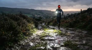 Close-up of a powerful LED beam from a budget running headtorch lighting up a dark British country path during winter training.