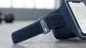 Athlete wearing the phone holder for running armband while exercising on a gym treadmill, with the phone screen clearly visible for tracking progress.