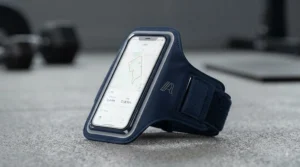 Detail shot of the running armband's integrated storage pocket, revealing a traditional house key and a folded £20 note securely stowed inside.