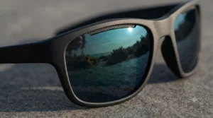 Close-up of polarised lenses on affordable running sunglasses demonstrating glare reduction outdoors.