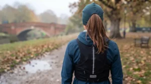 A runner adjusting a ponytail-friendly thermal running hat tailored for comfortable winter training.