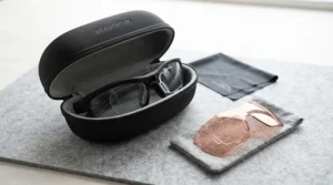Hard protective case and cleaning cloth for storing prescription running sunglasses.