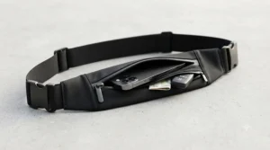 Close-up view of a running belt featuring a weather-resistant zip pocket designed to hold a smartphone securely.