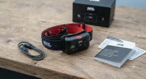 Unboxed running headtorch kit including the main light unit, adjustable headband, and micro-USB charging cable.