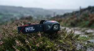 Water droplets beading on a durable, weather-resistant running headtorch built to withstand typical British rainy evening jogs.