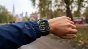 Close-up of an Apple Watch screen showing running cadence, heart rate, and split times.