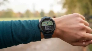 Close-up of a sports watch screen showing a live running route map and pace data