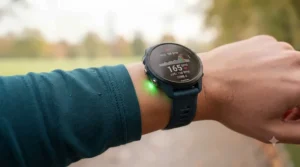 Runner checking real-time heart rate zones on their running watch wristband