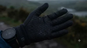 Textured silicone palm grip on a pair of lightweight running gloves for secure phone and water bottle handling.