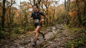 Durable heart rate monitor for running worn by a runner tackling a muddy cross-country trail